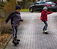 Boy_and_girl_on_skateboards